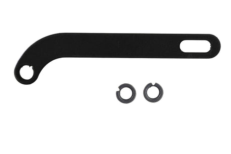 Black metal tool with two washers on a grid background