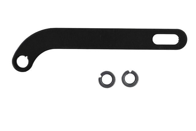 Black metal tool with two washers on a grid background